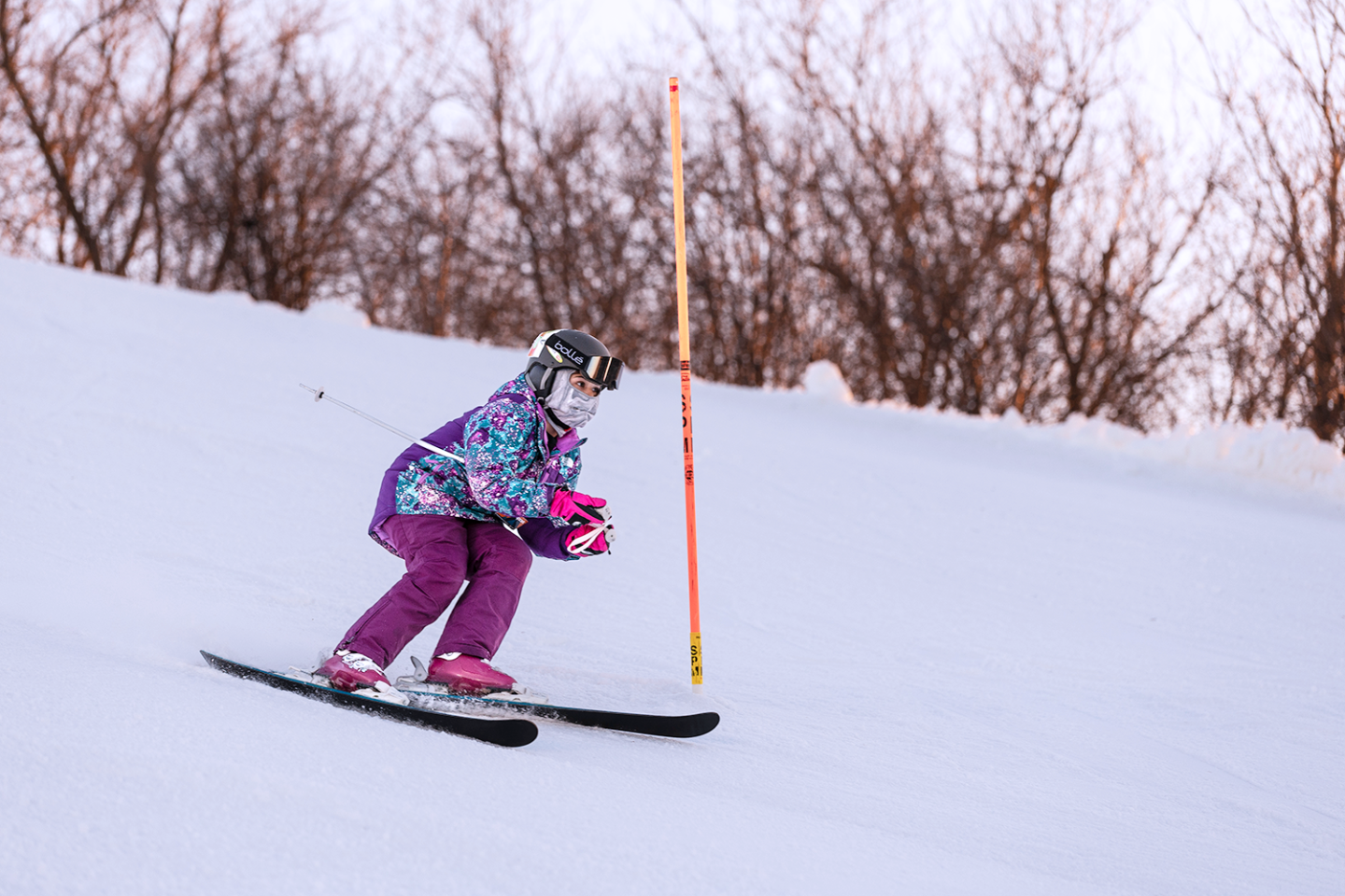child skiing down hill