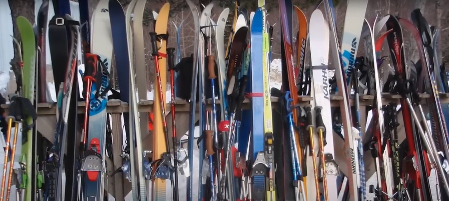 skis sitting on ski rack outside
