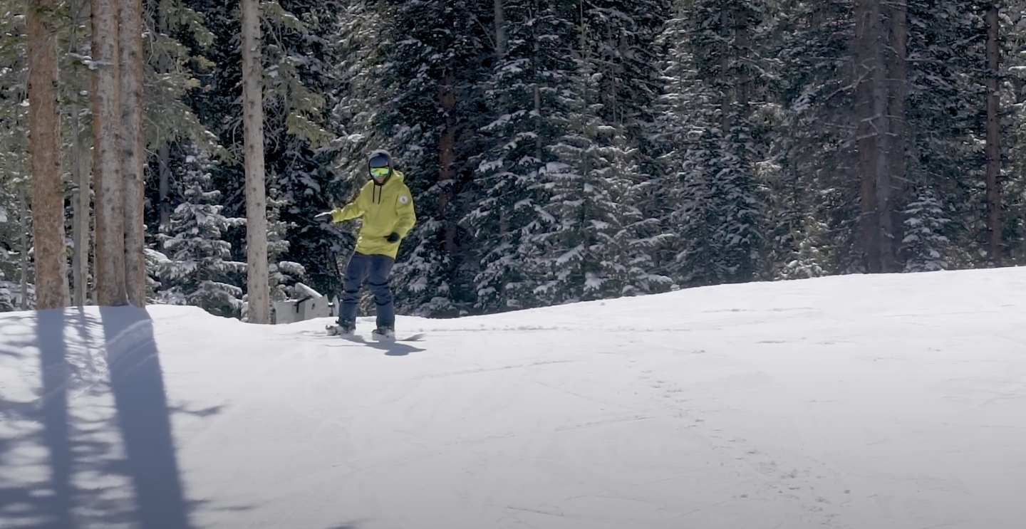 person on snowboard, on flat snow area