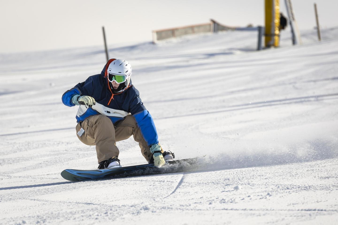 snowboarder going down hill