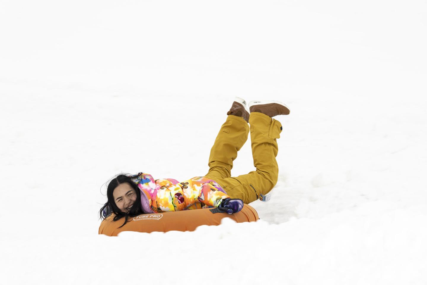 girl tubing down hill