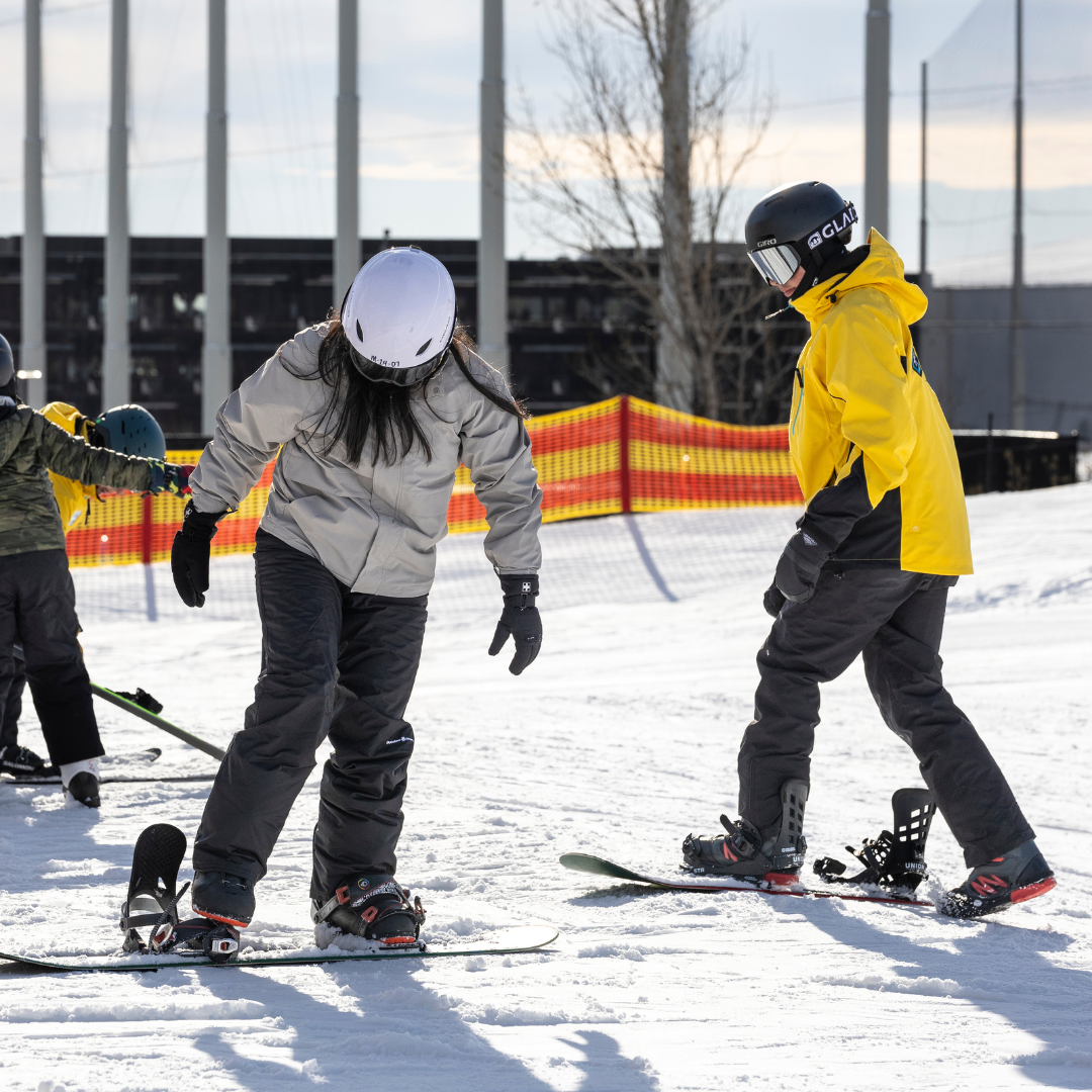 instructor and snowboarding student