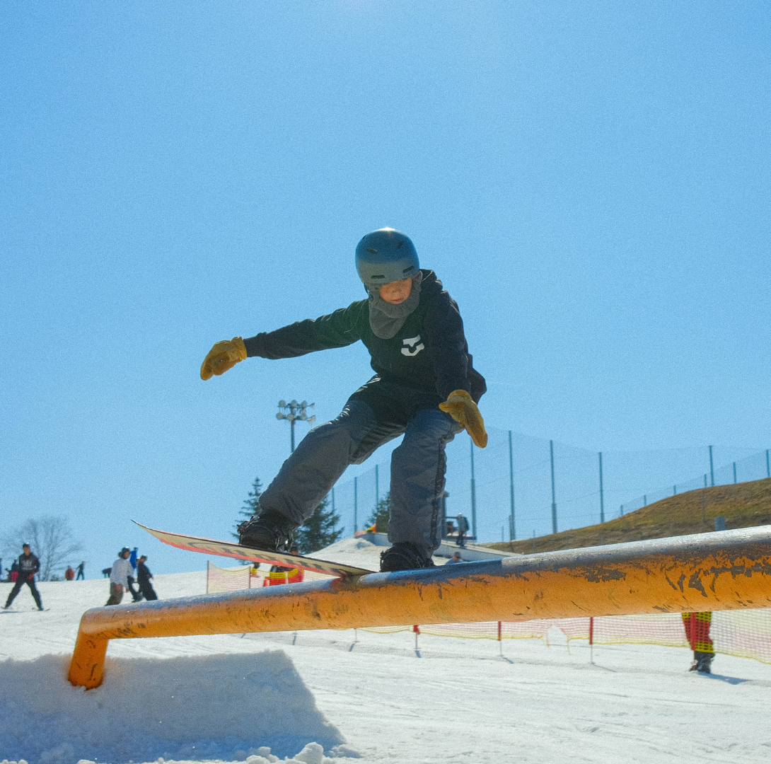 snowboarder on rail