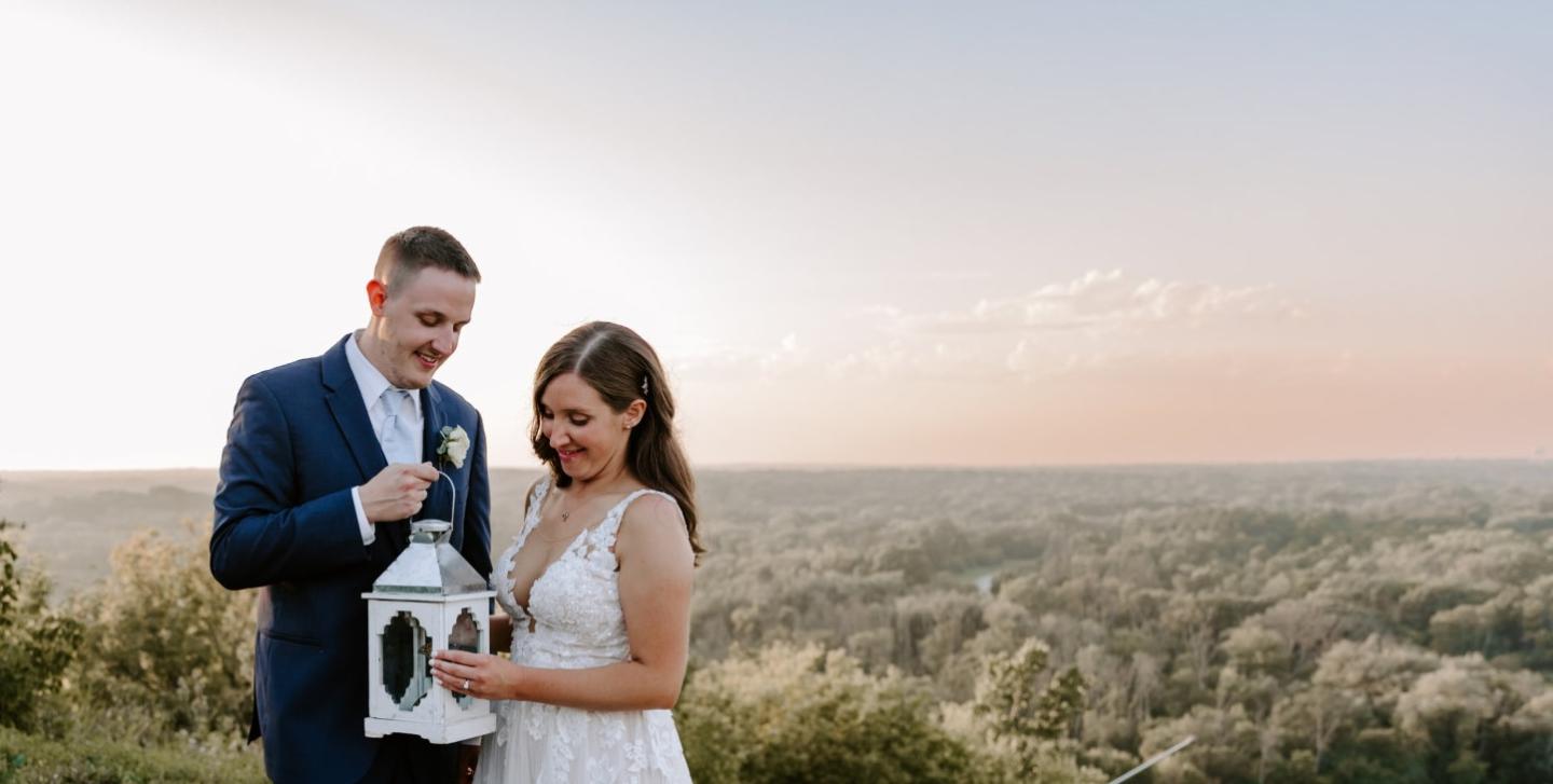 Bride and groom outdoors, smiling as they share a moment.